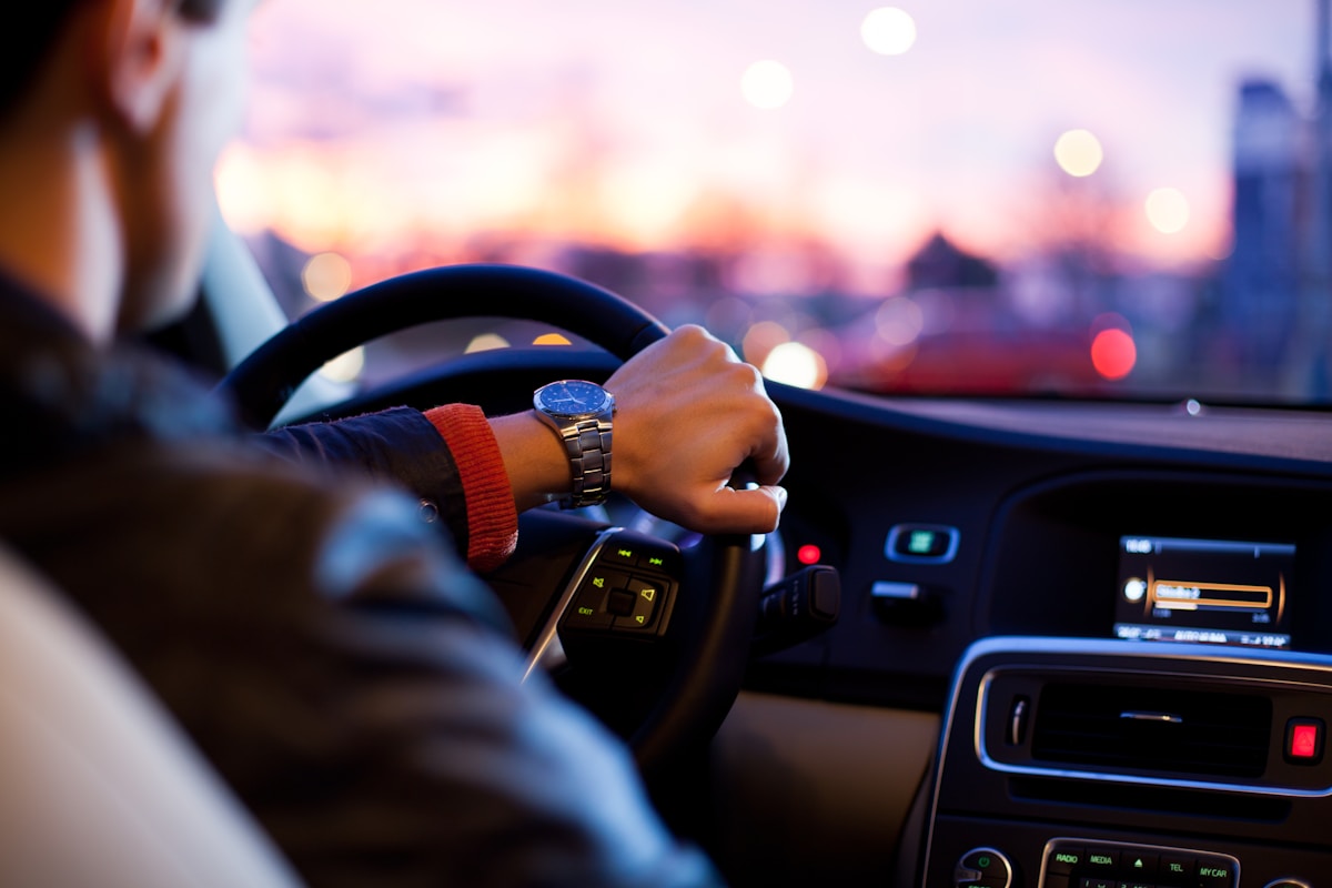Driver behind the wheel at sunset